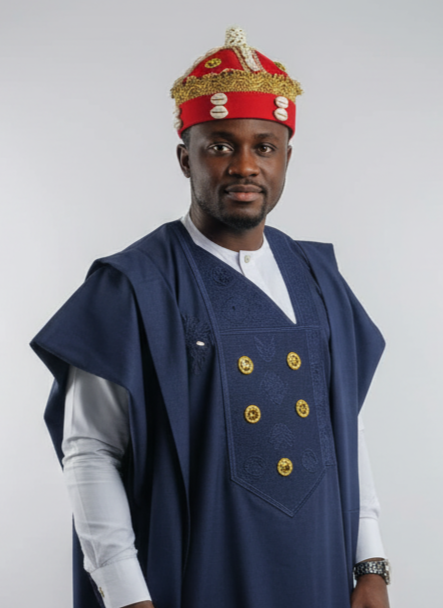 Man wearing a traditional outfit with a blue robe and red headgear on a white background