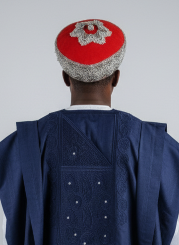 Person wearing a traditional outfit with a red cap on a white background